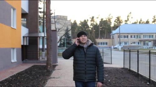 Young Adult Talking on Phone Outdoors