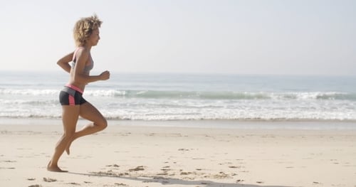 Woman Running On The Beach