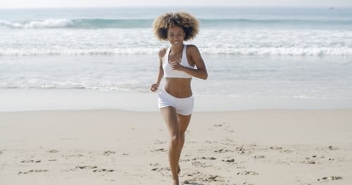 Sporty Woman Running At The Beach