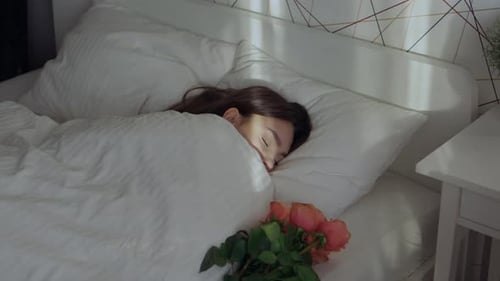 Woman Sleeping, Surprise Gift and Flowers in Bedroom