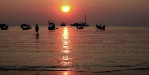 Walking On The Beach At Sunset