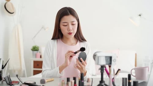 Young Woman Filming Beauty Tutorial at Home