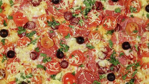 Rotating Pizza With Cheese, Tomatoes And Olives