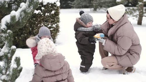 Adorable Mother and Toddler Kids Have Fun Togtether Outside in Sunny Frosrty Day