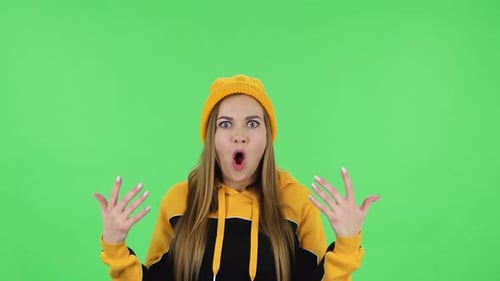 Young Woman Reacting with Surprise on Green Screen