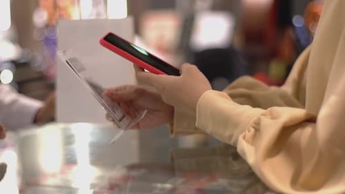 Asian Muslim Woman Using Mobile Phone To Scan QR Code