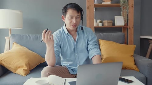 Young Adult Working at Home in Virtual Meeting