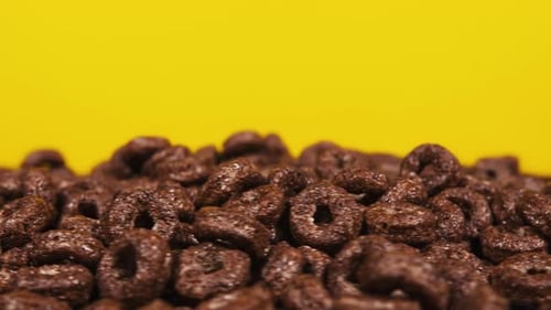 Chocolate Cereal Loops on a Yellow Background
