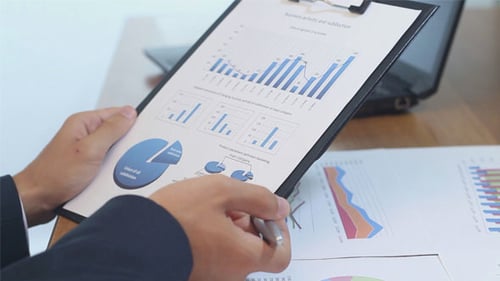 Business Professional Reviews Sales Chart in Office