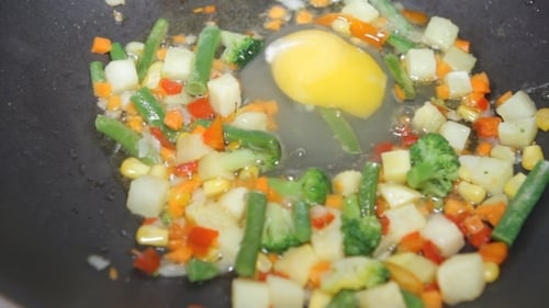 Cooking Eggs and Vegetables in Frying Pan
