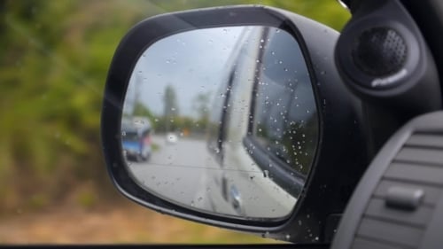 Driving In Rain. Side Mirror Of Car.