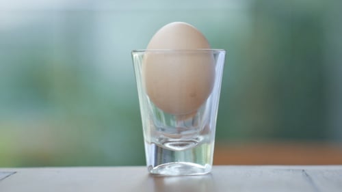 Cracking Fresh Egg into Glass for Cooking