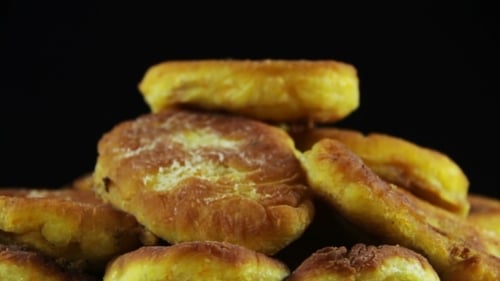 Delicious Fried Patties Rotating on a Dark Background
