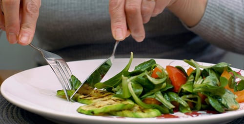 Preparing Salad with Zucchini and Tomatoes Close Up