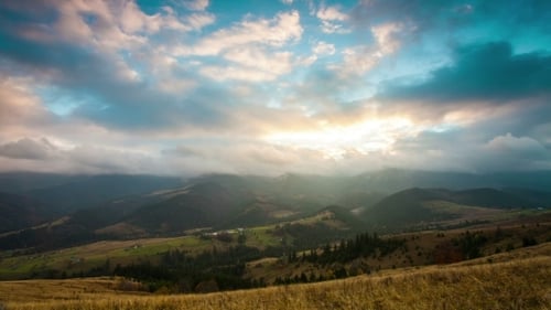 Mountain Peaks And Cloudy Sky.