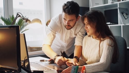 Team Collaboration on Graphic Design in Modern Office