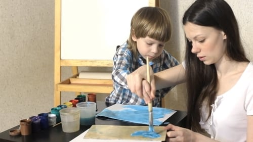 Woman and Child Painting Together at Home