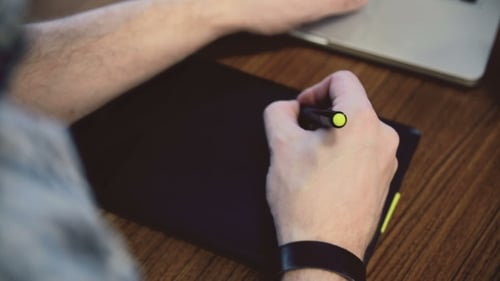 Artist Using Graphic Tablet at Work