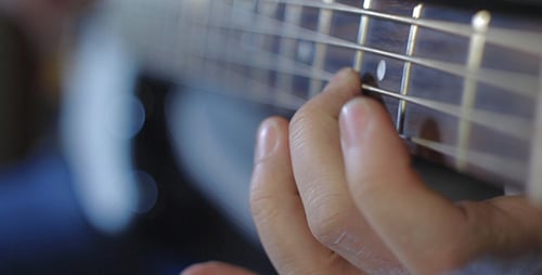 Hand Plucking Guitar String Close Up