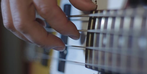 Close Up of Hand Playing Electric Bass Guitar