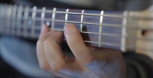 Close Up of Fingers Playing Guitar