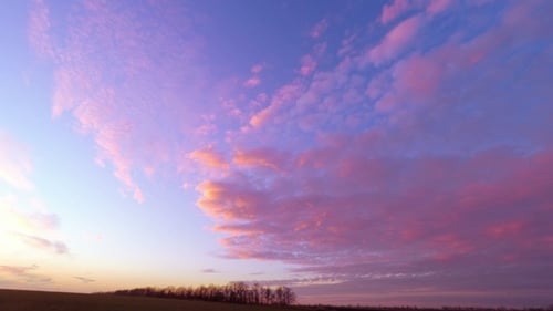 Vibrant Clouds at Sunset Over Rural Horizon