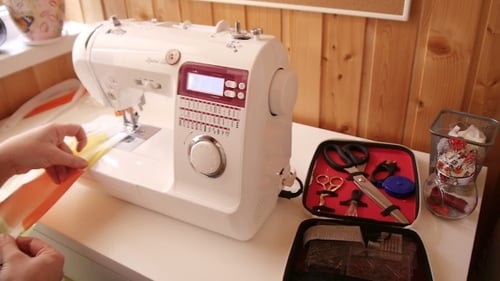 Beautiful Young Woman Sewing Clothes With Sewing Machine.