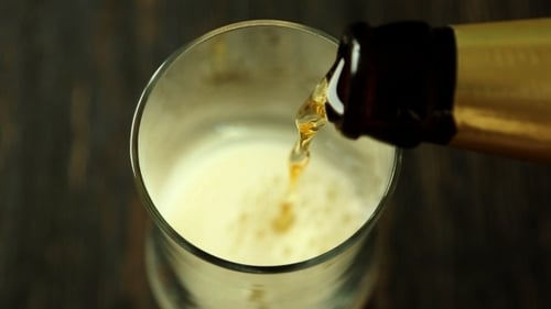Close Up of Beer Being Poured Into Glass