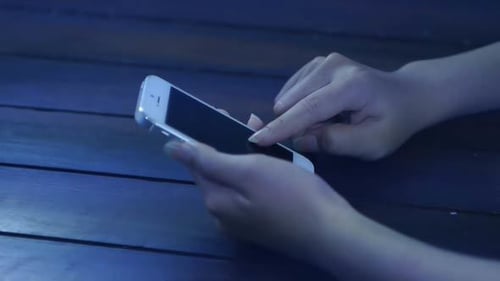 Hands Using Mobile Phone at Night