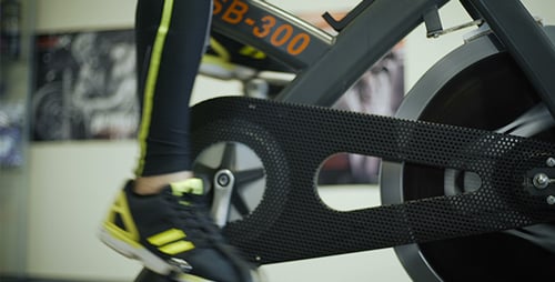 Sports Man Workouts On Gym Bicycle