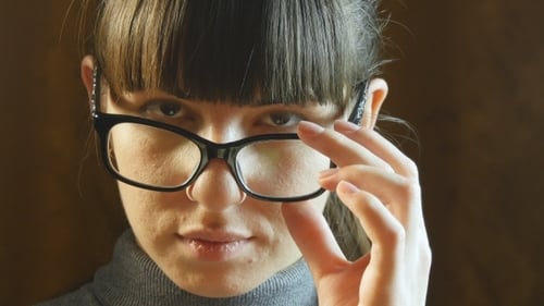 Woman Wearing Glasses Stares Intently Close Up