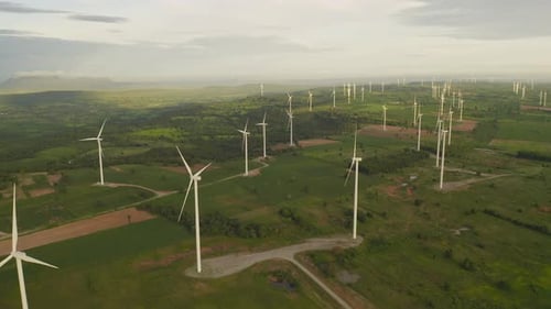 Aerial view of wind turbines or windmills farm field in industry factory. Power, sustainable green