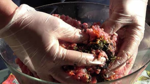 Mixing Ground Meat and Herbs in Bowl