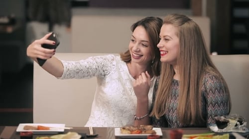 Two Pretty Girls Posing For a Selfie