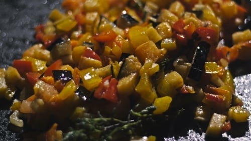 Cooking Diced Vegetables on a Black Pan