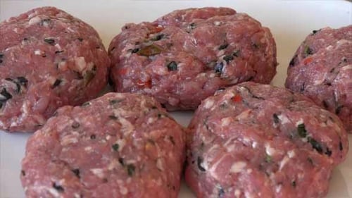 Ground Meat Patties Formed on White Plate