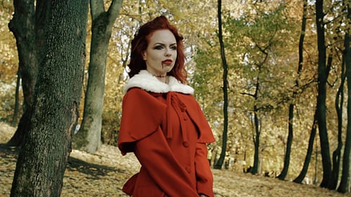 Woman in Red Coat in Autumnal Park