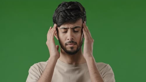 Close Up Male Portrait of Young Arabian Indian Unhealthy Sad Man Stressful Guy Massaging Temples