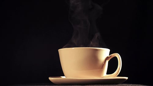 Steaming Cup of Coffee on Saucer