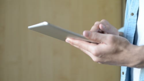 Hands Using Silver Tablet Computer Close Up