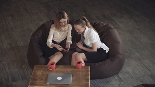 Relaxed Office: Women Collaborate on Beanbag Chair