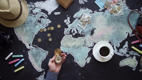 Planning Global Travel Adventure with Compass on World Map