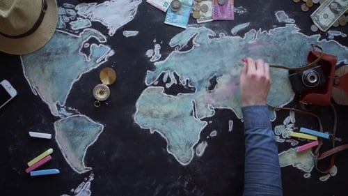 Planning Travel Routes on Chalkboard World Map