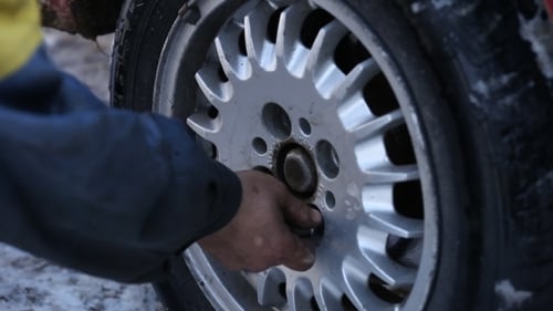 Worker Untwists Wheel