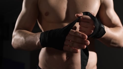 Muscular Torso Wrapping Hands with Boxing Tape