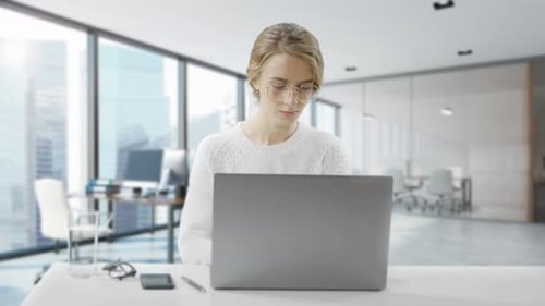 Woman Working on Laptop in Modern Office