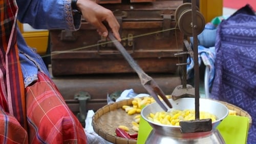 Woman Boils Silkworm Cocoons And Makes a Silk Thread. Traditional Asian Fabric Manufacture. Thailand