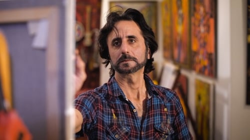 Portrait Of Male Artist Working On Painting In Studio