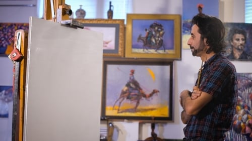 Man Contemplating Artwork in Art Studio