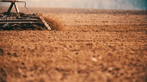Tractor Plowing Field At Sunset